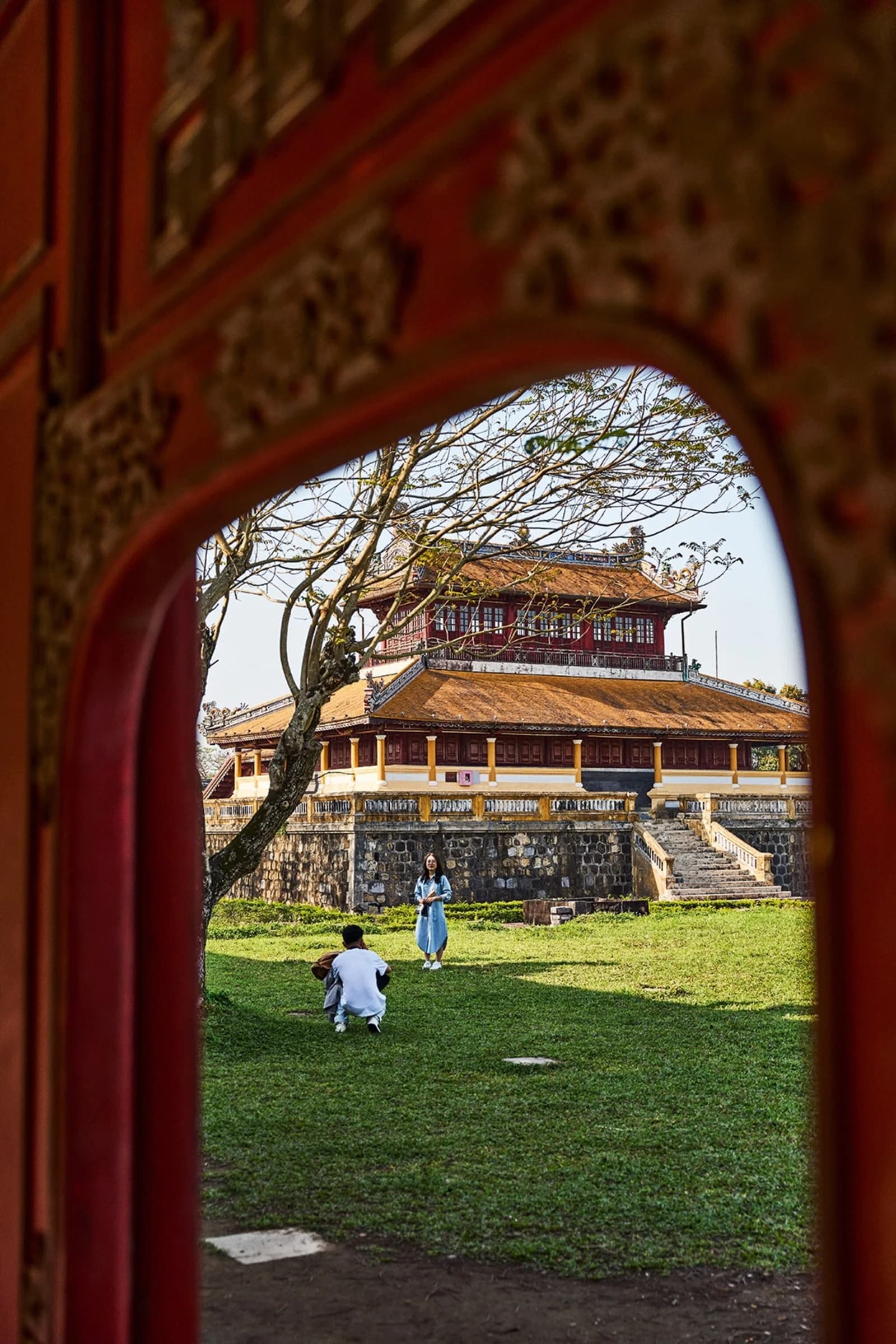 Visitors photographing historic architecture in Hue, central Vietnam