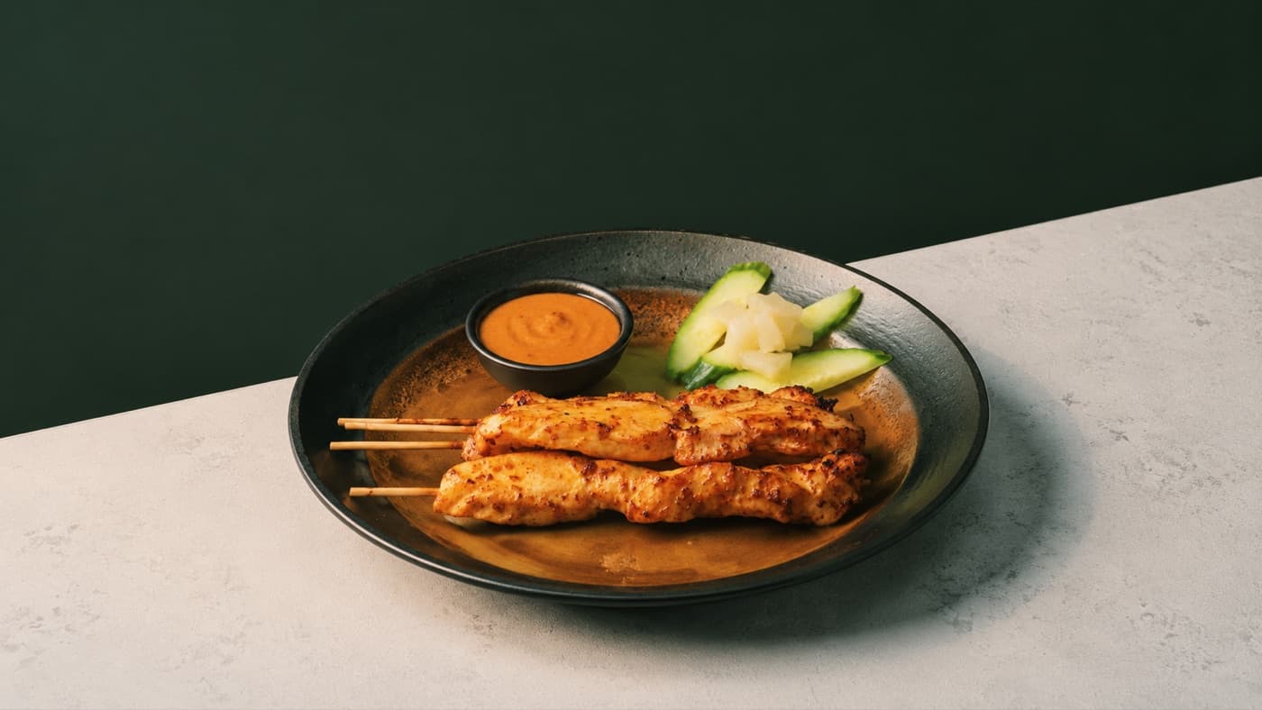 Pho District chicken satay skewers with dipping sauce