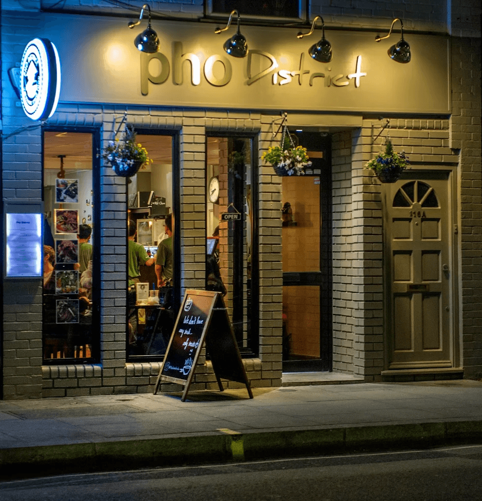 Pho District glowing on King Street at dusk